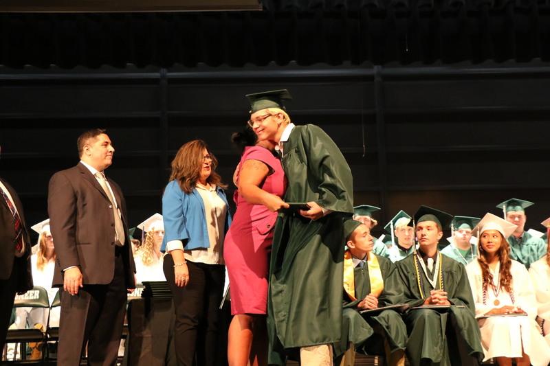 Jack Devitt gets a hug from his mom, Mellisa, during the presentation of diplomas.